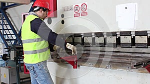 Worker bend metal plate on big machine 2