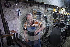 Worker is thrusting a metal sheet