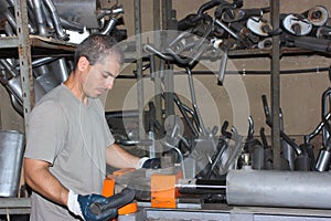 A worker bending pipe