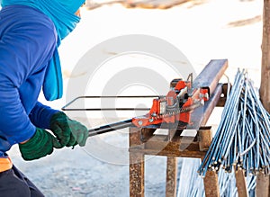 The worker is bending rebars rods steel