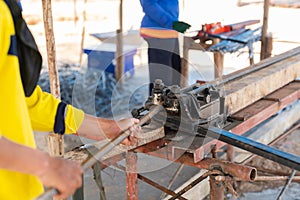 The worker is bending rebars steel rods