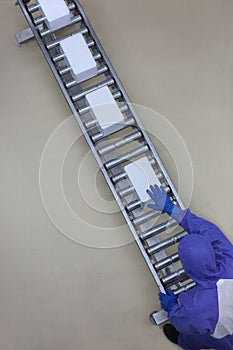 Worker in blue uniform working with boxes on packing line