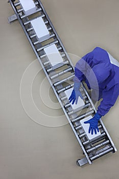 Worker in blue uniform working with boxes on packing line