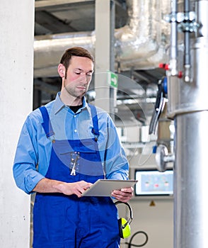 Worker with tablet computer  in industrial plant
