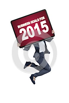 Worker with a board of business goals for 2015