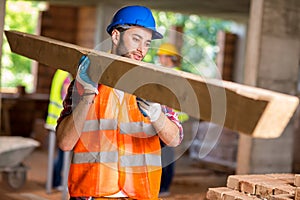 Worker bring construction timber photo