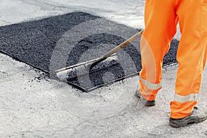 Worker brushing tarmac photo