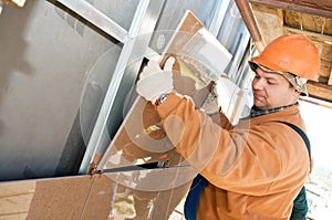 Worker builder at facade tile