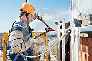 Worker builders at facade tile installation