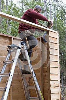 Worker Building DIY Storage Shed