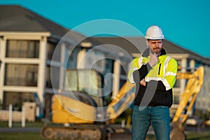 Worker at building site. Construction manager in helmet. Male construction engineer. Architect at a construction site