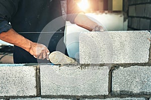 Worker building wall bricks