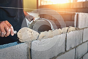 Worker building wall bricks