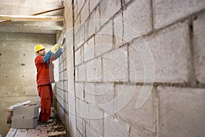 Worker Builds Cinder Block Wall - Horizontal