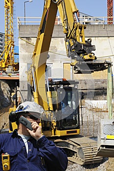 Worker and bulldozer, construction