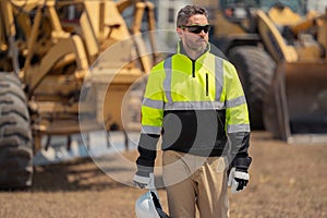 Worker with bulldozer on site construction. Man excavator worker. Construction driver worker with excavator on the