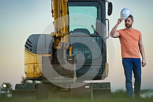 Worker with bulldozer on site construction. Man excavator worker. Construction driver worker with excavator on the