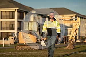 Worker with bulldozer on site construction. Man excavator worker. Construction driver worker with excavator on the