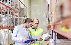 Worker and businessmen with clipboard at warehouse