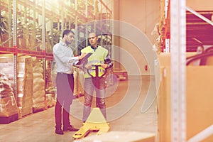 Worker and businessmen with clipboard at warehouse