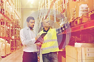 Worker and businessmen with clipboard at warehouse