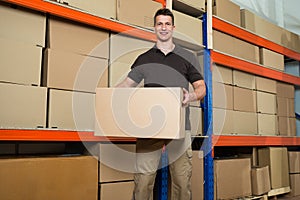 Worker With Cardboard Box In Warehouse