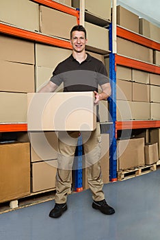 Worker With Cardboard Box In Warehouse