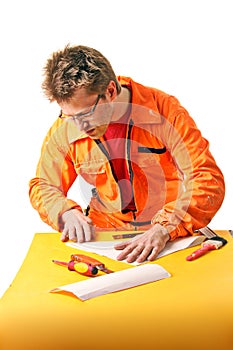 Worker carefully folds a paper sheet