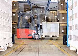 Worker Carrying Goods On Forklift