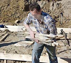 Worker carrying planks