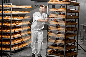 Worker carrying shelves with bread