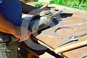 a worker changes a grinding disc that wasted during metal cutting