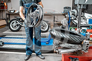 Worker changing a motorcycle tire