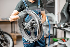Worker changing a motorcycle tire