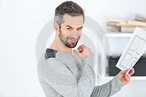 worker checking plan on construction site