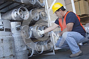 Worker checking the pressure of cylinder