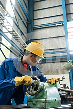 Worker checking quality behind an industrial machine