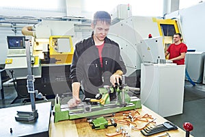 Worker checking quality of processed tool