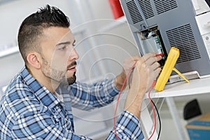 Worker checking quality processed tool using precise device