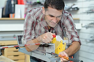 Worker checking quality processed tool using precise optical device