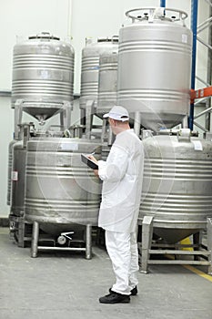 Worker checking stocks in foodstuff storehouse