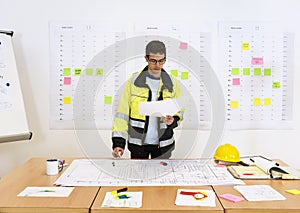 Worker checking technical drawings