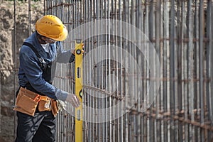 Worker checks the construction parameters of foundation