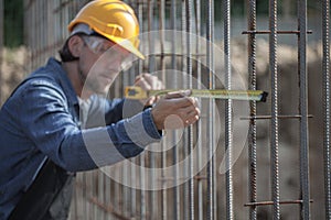 Worker checks the construction parameters of foundation