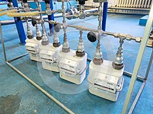 Worker checks methane gas consumption on gas flow meters. Industrial gas meter