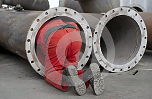 Worker checks a steel pipe