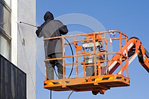 A worker in a cherry-picker