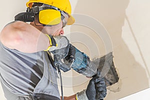 Worker Chiseling Concrete