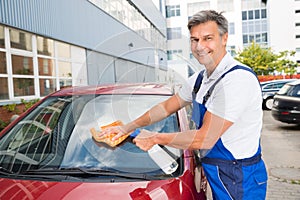 Worker Cleaning Car Windshield