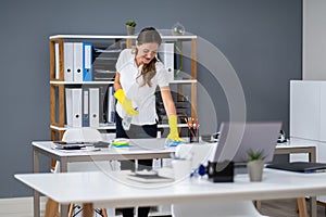 Worker Cleaning Desk With Rag